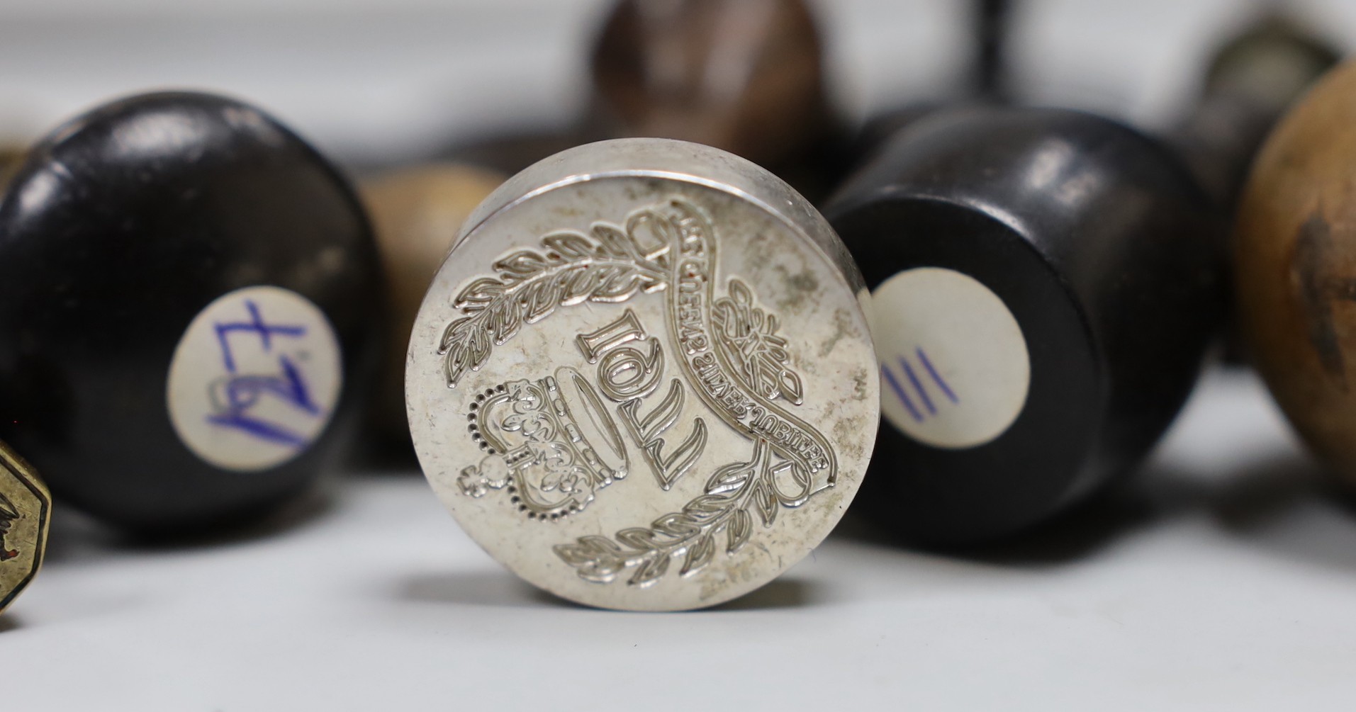 A selection of wood-mounted desk seals, 19th/20th century, together with some treen cased wax armorial samples, and other curios